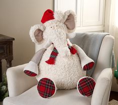 a white stuffed animal sitting on top of a chair