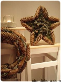 two wreaths made out of pine cones are sitting on a shelf next to each other