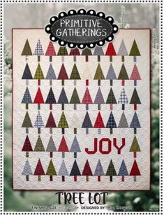 a christmas tree quilt with the words primitive gatherings on it and trees in red, green