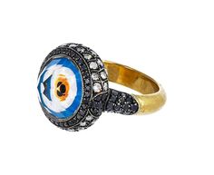 Brilliantly imagined and executed to the most perfect, exquisite detail, this one-of-a-kind Sevan Bicakci ring embodies the traditional symbol of protection against negativity. Perfectly, masterfully hand-crafted, the three dimensional evil eye has been created by intaglio carving - a technique using reverse carving from the underside of the stone - into the underside of the faceted rock quartz. Painstakingly painted to precision, the vibrant eye is encased in the stone which is framed by an int Sevan Bicakci, Symbol Of Protection, Vibrant Eyes, Evil Eye Ring, Micro Mosaic, Diamond Quartz, Fancy Diamonds, Eye Ring, Clothing Design