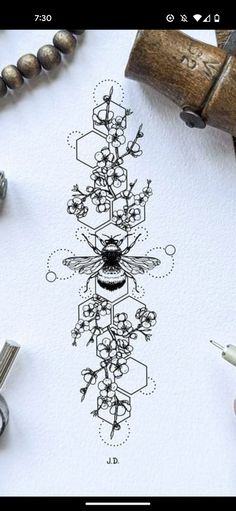 a drawing of a bee on top of a piece of paper next to some scissors