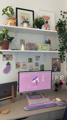 a desktop computer sitting on top of a desk next to a keyboard and mouse in front of a plant