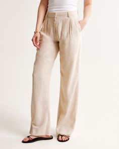 Our signature A&F Sloane Tailored Pant with a low rise, in our breezy linen-blend fabric, that's perfect for dressing up or down. Featuring figure-flattering pleating details, a functional fly and pockets and a partially elasticated waistband for ultimate adjustability. The intended length hits the bottom of a flat shoe. Please reference our size chart to determine your perfect size and inseam! Chic Relaxed Fit Flax Bottoms, Fitted Full-length Linen Pants, Spring Full-length Linen Bottoms, Summer Relaxed Mid-rise Pants, Chic Full Length Linen Pants, Relaxed Fit Full Length Linen Bottoms, Relaxed Fit Full-length Linen Bottoms, Relaxed Fit Linen Bottoms Full Length, Full Length Linen Bottoms For Work