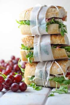 a stack of sandwiches wrapped in white paper