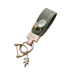 a keychain with a leaf charm attached to it