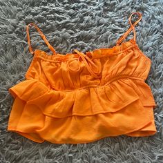 Wild Fable/ Orange Ruffle Crop Top Never Worn It Never Fit Me Right Looks A Lot Better On A Smaller Chest Btw All Straps Are Adjustable And The Tie In The Front Brand New Condition Super Cute For Summer, Love Make An Offer! Spring Vacation Crop Top With Ruffles, Flirty Ruffled Crop Top For Brunch, Vacation Ruffle Crop Top, Vacation Ruffled Crop Top, Cropped Ruffle Top For Beach, Ruffled Cropped Tops For Beach, Flirty Tops With Ruffle Hem For Vacation, Summer Tiered Tops For Vacation, Tiered Ruffle Hem Top For Vacation