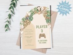 a card with a video game controller on it next to some flowers and greenery