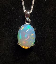 Beautiful Natural Opal Necklace, 11x15mm 4.5 Carat Ethiopian Opal, See Video! 925 Sterling Silver Pendant, Rhodium Plated, 18" Sterling Silver Chain. Velvet Necklace Box Included. Sterling Silver Necklace With Bail As A Gift, Silver Oval Necklace With Bail, Opal Necklace Silver, Velvet Necklace, Beautiful Gemstones, Pretty Jewelry, Necklace Box, Opal Necklace, Natural Opal