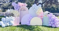 balloons and archs in the shape of hearts are on display at an outdoor event