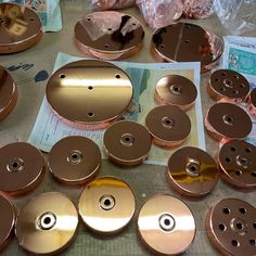 many different types of metal discs on a table