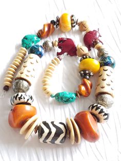 Limited Edition. Only 1 in stock.Who doesn't love an organically beautiful necklace that's light and eclectic? The Juke Joint necklace is exactly that and more. Made with repurposed beads from a vintage carved bone necklace, I took some of those elements and fashioned them into a stylishly bohemian look by adding in some great bold color elements of warm orange and yellow copal amber resin, hand-blown lampwork glass bead orbs, a batik bone focal and fun maroon carved red elephant collarbone foca Red Elephant, Juke Joints, Amber Resin, Bone Necklace, Carved Bone, Bohemian Look, Bone Carving, Lampwork Glass Beads, Men's Necklace