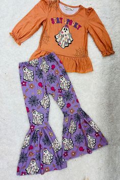 Top features "STAY SPOOKY" wording w/a cute ghost print on solid washed orange background w/ruffles & long sleeve cut. Bottoms feature ghost, spider webs, & flower prints on light purple background & flare legs. Soft, breathable, stretchy, and comfortable fabric. Adorable outfit for the perfect Halloween look. Material: Polyester & Spandex. Includes: Top & Bottoms. Spooky Words, Light Purple Background, Ghost Spider, Ghost Print, Skirt Swimsuit, Stay Spooky, Spider Webs, Spooky Ghost, Mommy And Me Outfits