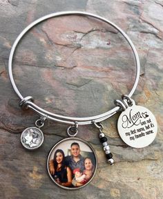 "Mom bracelets feature your favorite photo, Mom saying engraved in stainless steel, matching beads, and your choice of rhinestone color. Options to add more photos and rhinestones are available at checkout. These make great gifts!! INCLUDES: - Photo Charm - Saying as shown - Rhinestone (your choice of color) - Matching Beads Bracelets are made of stainless steel and come in 3 sizes: - Large 2.6\" (larger wrists/hands) - Average 2.4\" (fits most) - Child 2.0\" (elementary school age or tiny wrist Customizable Metal Jewelry For Mother's Day, Customizable Stainless Steel Jewelry For Personalized Gifts, Customizable Stainless Steel Jewelry For Mother's Day, Personalized Stainless Steel Jewelry For Mother's Day, Customizable Silver Bracelets As Gift For Mom, Personalized Round Stainless Steel Jewelry, Hypoallergenic Stainless Steel Jewelry For Memorial, Personalized Round Bracelets For Keepsake, Mother's Day Engraved Stainless Steel Charm Bracelet