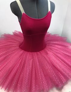 a mannequin wearing a pink tutu with silver sequins on it