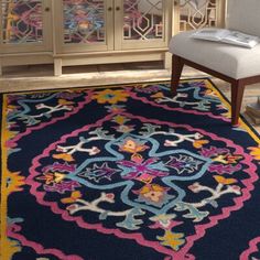 a blue area rug with colorful designs on it