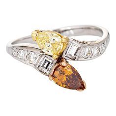 This is part of Chairish’s Fine Jewelry assortment.  Stylish vintage colored diamond 'moi et toi' ring crafted in 14k white gold.   One pear cut yellow diamond is estimated at 0.38 carats (estimated at SI2 clarity) and one pear cut brown/orange diamond estimated at 0.60 carats (estimated at SI2 clarity). Single & emerald cut diamonds total an estimated 0.18 carats (estimated at H-I color and VS2-SI1 clarity). The colored diamonds show evidence of irradiation.    The two stone design or "Toi et M Orange Diamond, Gold Cocktail Ring, Right Hand Rings, Alternative Engagement Rings, Ring Crafts, 14k White Gold Ring, Stone Design, Emerald Cut Diamonds, Yellow Diamond