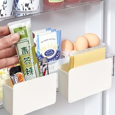 a refrigerator door is filled with eggs, milk and other food in containers on the shelves