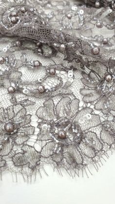 Essential Gray Beaded Lace Trim, Handmade embroidery, Eyelash lace, Chantilly Lace, French Lace,Bridal lace, Evening dress lace, Couture lace  Article: MK00518 Width: 13 cm listed for one meter (100 cm x 13 cm) Colors: Essential Gray with beads and sequins Lace edge: Both sides scalloped Composition: Polyamide, Cotton The price is per meter (1 meters= 100 cm / 39.4 inch) Biggest one-piece is 4,20m IMPORTANT: Please note, there might be a slight difference in the color according to PC and Mobile Elegant Beaded Lace Embroidered Fabric, Embroidered Lace Fabric For Evening, Evening Embroidered Lace Fabric With Lace Work, Evening Lace Fabric With Embroidered Lace Work, Lace Couture, Grey Beads, Lace Bridal, Handmade Embroidery, Lace Evening Dresses