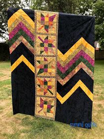 two black quilts with yellow, pink and green chevroned strips on them