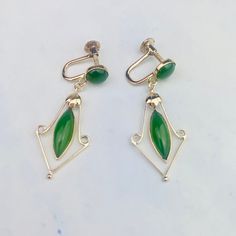 "These beautiful vintage mid-century drop earrings are acquired from an estate auction. The 18K yellow gold heavy earrings feature one round cabochon and one marquise cabochon jade set in bezel setting on each earring and a dangling gold floral frame around the marquise stone. Screw backs tighten securely.  The earrings are 35.6mm (1.40\") long and 14.2mm (0.56\") wide at its widest point, they weigh 3.943 grams. They are marked 18K, and CKP and KPT on the back of the screws, C on one and T on t Gold Heavy Earrings, Heavy Earrings, Floral Frame, Gold Floral, Screw Back Earrings, Bezel Setting, Jade, Vintage Outfits, 18k Gold