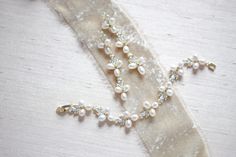 "Featuring a gorgeous combination of crystals and freshwater pearls, this bracelet and earrings set is the perfect piece to add to your bridal look for a touch of vintage meets modern glam! - Bracelet measures 6\" x 0.5\" - Earrings measure 2.5\" x 0.5\" - Made with high quality cubic zirconia and freshwater pearls - Available in rose gold, yellow gold and rhodium (silver) finishes Browse My Entire Shop For More Jewelry & Accessories: https://www.etsy.com/shop/TheExquisiteBride Browse My Sho Elegant Wedding Jewelry Sets With Bracelet Shape, Elegant Wedding Jewelry Sets With Bracelets, Wedding Elegant Jewelry Sets With Bracelet, Elegant Wedding Jewelry Sets Including Bracelet, Elegant Rose Gold Pearl Bracelet For Wedding, Delicate Pearl-embellished Jewelry For Mother Of The Bride, Dainty Rose Gold Pearl Bracelet For Wedding, Rose Gold Bracelets With Pearl Charm For Wedding, Rose Gold Pearl Bracelets For Wedding