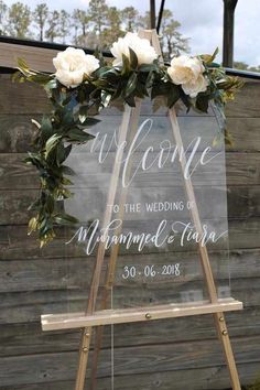 a welcome sign with flowers on it