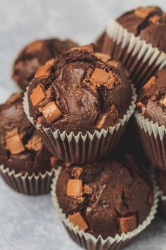 several chocolate muffins stacked on top of each other