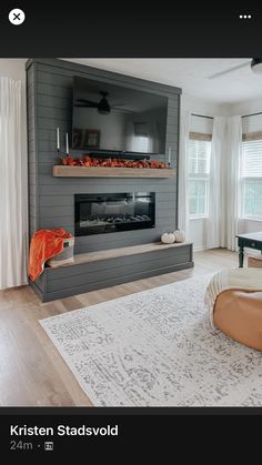 a living room filled with furniture and a flat screen tv mounted on the wall over a fireplace