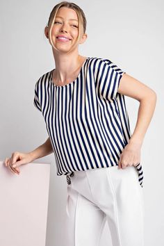 STRIPED CAP SLEEVE BLOUSE TOPStripe printed short sleeve blouse top featuring a rounded neckline, cap sleeves, a button and keyhole closure in the back and is a lightweight top perfect for the Spring season. 100% POLYESTER Measurements: Bust: small 44", medium 46", large 48" Length: small 26", medium 26.5", large 27" Cap Sleeve Blouse, Cap Sleeves Blouse, Cap Sleeve Top, Rounded Neckline, Lightweight Tops, Navy Stripes, Spring Season, Blouse Top, Short Sleeve Blouse