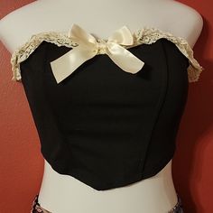 Offered Is A Fantastic Black Bustier With Ivory Double Ruffle Lace And Satin Ribbon Trim. Gummed Top For Non Slip. Flexible Plastic Boning (4). New Without Tags, Made By Shein. Size Small. All Measures Are Approx. Bust 31" Bottom 27" Length Center 10" Length Side 7" Fabric Content: 95% Polyester 05% Elastane P41 Fitted Strapless Crop Top With Lace Trim, Strapless Fitted Crop Top With Lace Trim, Lace Trim Bandeau Crop Top, Strapless Tops With Lace Trim For Night Out, Black Strapless Top With Lace Trim, Chic Strapless Top With Lace Trim, Bandeau Cotton Tops For Party, Cotton Bandeau Tops For Party, Free Crop Tops