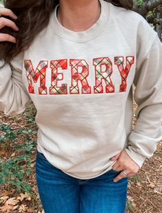 "MERRY APPLIQUE EMBROIDERED APPAREL ♡ Heavy Blend Crewneck Sweatshirt - Unisex ♡ Merry Applique Crewneck ♡ 50/50 Cotton/Polyester ♡ Made in the U.S. ♡ Model is wearing \"Sand\"; Size: \"S\" IMPORTANT NOTICE: Crewnecks now have a paper like stabilizer that appears on the inside. This helps with increasing quality and ensure a longer lasting design on the sweatshirts. NOTE: INVENTORY IS CONSTANTLY CHANGING. We may need to alter your order if something becomes sold out. Sorry for this inconvenience, but we are working on resolving this issue. Please message Kewteepie if a larger size is needed and we will check on sizes available for accommodation. ----------------------------------------------------------------------- CREWNECKS RUN ON THE SMALLER END, WE RECOMMEND SIZING UP FOR A LOSER FIT!! Embroidered Apparel, Diy Sweatshirt, Reverse Applique, Christmas Crewneck, Embroidered Crewneck, Holiday Sweatshirt, Shirt Embroidery, Embroidered Clothes