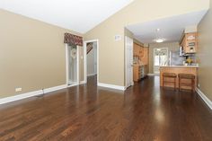 an empty living room with hard wood floors and white trim on the walls is shown