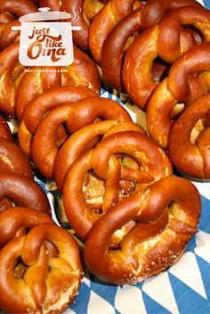 some pretzels are sitting on a blue and white checkered tablecloth with a sign that says just like one