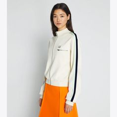 Our new track jacket — a staple of '70s sportswear — is detailed with side stripes and a chest zip pocket. Crafted in tech knit, the versatile layer can be worn for sports or every day. 70s Sportswear, Tennis Sweater, Womens Golf Fashion, Womens Golf, Designer Jackets, Hi End, Golf Fashion, Tennis Skirt, Sweater Design