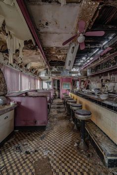 an old run down restaurant with checkered flooring and peeling paint on the walls