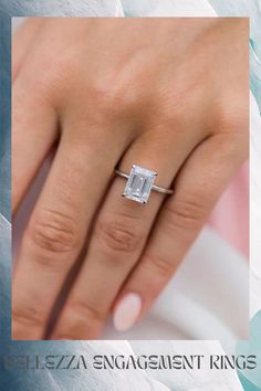 a woman's hand with a diamond ring on it