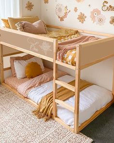 a wooden bunk bed sitting in a bedroom next to a window with flowers on it