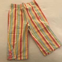 Vertical Striped Capri Pants In Bright Rainbow Fruit Colors - Red, Orange, Yellow, Green, Blue And Pink. Has Pretty Pink Lace Ties On Bottoms. From The Gymboree Tutti Fruity Line. Playful Long Pants For Playtime, Playful Multicolor Spring Pants, Cute Yellow Bottoms For Playwear, Fun Multicolor Cotton Pants, Multicolor Bottoms For Playtime In Spring, Fun Multicolor Pants For Spring, Fun Multicolor Spring Pants, Yellow Cotton Playwear Bottoms, Cute Yellow Bottoms For Playtime