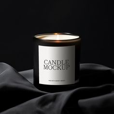 a candle that is on top of a black cloth with the words candle mockup