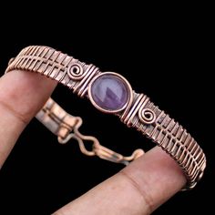 Amethyst Cuff Bracelet Amethyst Gemstone Bangle Copper Wire Wrapped Cuff Bangle Wire Wrap Bracelet Jewelry Handmade Copper Bangle Bracelet Main Stone - Amethyst Bangle Length - 2.50 - 2.75" Inches (Adjustable) Bangle Width  -  0.50 Inches Metal                  -  Copper Copper Has Been Used For Jewelry Making For Thousands Of Years, Dating Back To Ancient Civilizations Such As The Egyptians, Romans, And Aztecs. Copper Was Valued For Its Beauty, Versatility, And Durability, And Was Often Used To Adjustable Purple Bohemian Cuff Bracelet, Adjustable Bohemian Amethyst Cuff Bracelet, Handmade Amethyst Cuff Bangle Bracelet, Handmade Purple Metal Bracelets, Handmade Amethyst Bangle, Handmade Amethyst Bangle As A Gift, Handmade Amethyst Bangle For Gift, Adjustable Amethyst Cuff Bracelet Gift, Amethyst Bangle For Gift