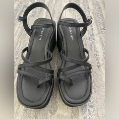 Madden Girl Sandals Size 9 Brand New Trendy Black Wedge Sandals With Heel Strap, Black Adjustable Platform Wedge Sandals, Adjustable Black Platform Wedge Sandals, Black Strappy Synthetic Sandals, Black Strappy Synthetic Wedge Sandals, Trendy Strappy Synthetic Wedge Sandals, Trendy Black Adjustable Wedge Sandals, Black Strappy Wedge Sandals For Vacation, Adjustable Black Synthetic Wedge Sandals