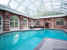 an indoor swimming pool with two people in it