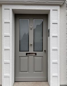 a grey front door with two glass panels