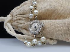 This bracelet style watch has 28 Pearls strung in 14k white gold. The watch face has 25 small white diamonds that encircle it. The watch is not only beautiful, but it is in remarkable condition and working. Made in around 1910 with a manual winding action, this timepiece will add beauty to the everyday task of telling time. The watch manufacturer Dreyfus Frères & Co. opened a luxury sister company in 1903 in Péry, Switzerland and called it simply 'Pery'. Unfortunately the Péry watch company did Platinum Wedding Watch, Round, Wedding Platinum Watches, Round Shape, Platinum Diamond Watch For Evening, Platinum Diamond Watch For Wedding, Platinum Round Diamond Watch For Evening, Platinum Wedding Watch, Platinum Diamond Wedding Watch, Wedding Platinum Watches, Evening Round Watch With Jubilee Bracelet