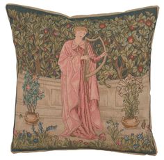 a decorative pillow with an image of a woman holding a harp in front of fruit trees