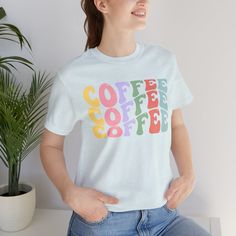 Indulge in the cute cozy charm of our pastel Coffee tee, where soft hues blend seamlessly with your love for caffeine, creating a stylish and comfy statement piece for your everyday brew adventures. Coffee t-shirts, caffeine tees, local cafe shirt S M L XL 2XL Width, in 17.99 20.00 22.01 24.02 25.98 Length, in 27.99 29.02 30.00 31.02 32.01 Sleeve length, in 8.90 9.17 9.45 9.72 10.00 Cute Blue T-shirt For Loungewear, Comfortable Blue T-shirt For Everyday, Casual Coffee-colored Screen Print T-shirt, Retro Blue Soft-washed T-shirt, Casual Coffee Crew Neck T-shirt, Blue Graphic Print Comfortable T-shirt, Comfortable Blue Graphic Print T-shirt, Casual Coffee Colored Screen Print T-shirt, Casual Coffee T-shirt With Screen Print