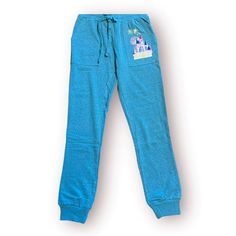 Step into the magic with this Blue Joey Chou Disney World Pants. Designed by the renowned artist Joey Chou, these pants feature a whimsical blend of Disney enchantment and artistic flair. The vibrant blue color adds a modern touch, while the Disney World theme brings nostalgic charm. Elevate your casual style with this unique and comfortable pair, perfect for expressing your love for Disney in a fashionable way. ** Authentic Disney Parks merchandise. ** Disney Cotton Loungewear Pants, Disney Cotton Pants For Loungewear, Joey Chou, Blue Castle, Disney Merchandise, Disney Star Wars, Shop Mens Clothing, Vibrant Blue, Baby Disney