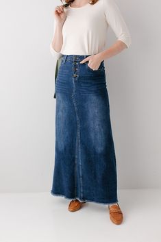 A long denim skirt so comfortable you will never want to take it off! The 'Haven' denim skirt in dark wash is made out of a stretch denim to keep you comfy wherever life takes you! This skirt has all of the vintage features you love- buttons up the front, working pockets, an A-line design, and a raw edge hem. Exclusively designed by us, for you! 97% Cotton 3% Spandex Wash Cold Gentle Cycle Hang to Dry Low Iron if Needed Model Height 5'8" | Wearing Size 2 Wearing 'Shelly' Bamboo Blend Ribbed Tee Long Dark Denim Skirt Outfit, Dark Denim Skirt Outfit, Modesty Matters, Dark Denim Skirt, Ribbed Tee, Denim Skirt Outfits, Long Denim Skirt, Puff Sleeve Top, Knitted Cardigan