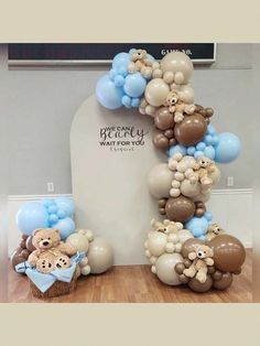 balloons are arranged in the shape of a number with teddy bears and blue, brown, and white balloons