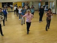 a group of people dancing in a large room